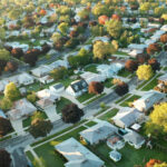 Aerial view of residential houses at autumn (october). American neighborhood, suburb. Real estate, drone shots, sunset, sunny morning,  sunlight, from above